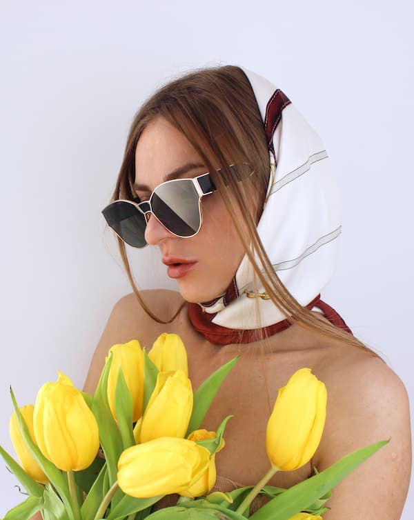 Luxury shopping in Lisbon Must de Cratier silk scarf with yellow tulips makeup editorial beauty face